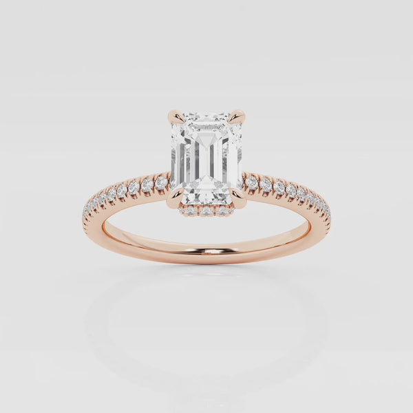 Emerald solitaire engagement ring with hidden diamond halo and pavé band in Rose Gold