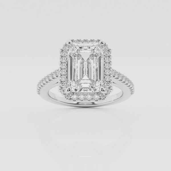 Halo emerald cut engagement ring with pave set diamond shoulders