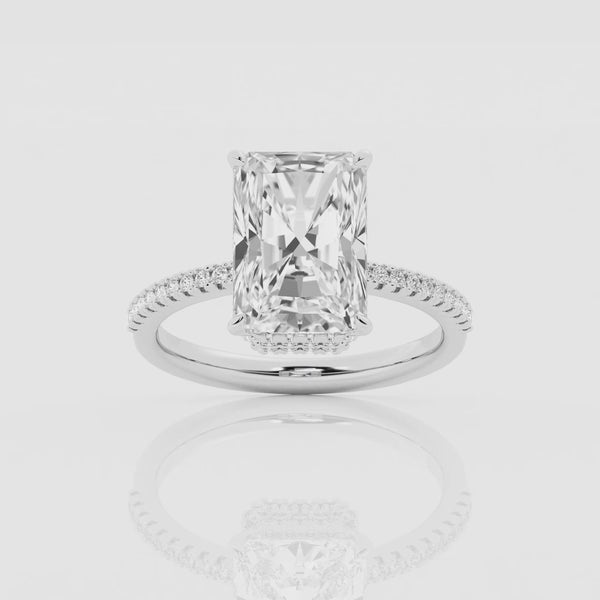 Double hidden halo emerald cut engagement ring in 18k white gold